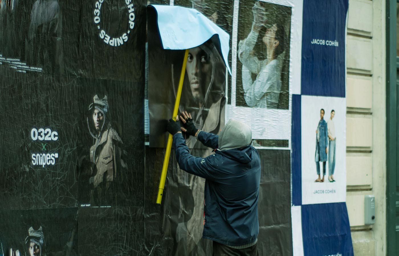 Wheatpaste poster installation by street teams in Austin